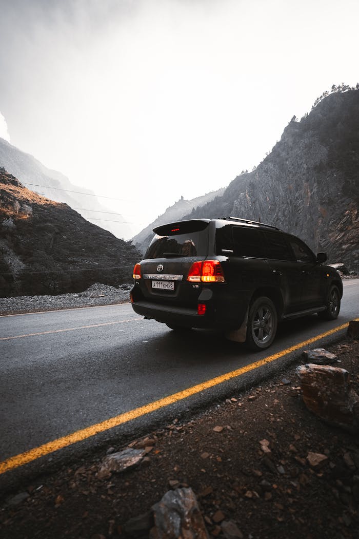 Mastering the First Impression: Your intriguing post title goes here A Toyota SUV travels along a scenic mountain road in Dagestan, Russia, with a dramatic backdrop.
