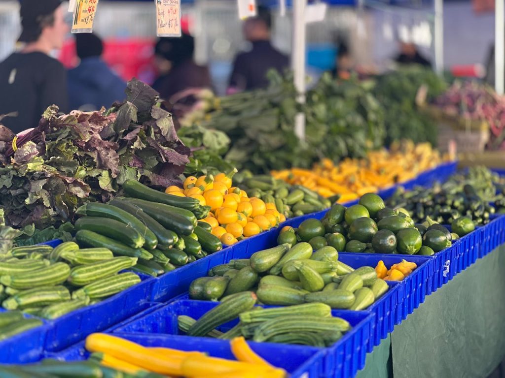 pexels photo 28991059 Colorful array of fresh vegetables in baskets at an outdoor farmers market.