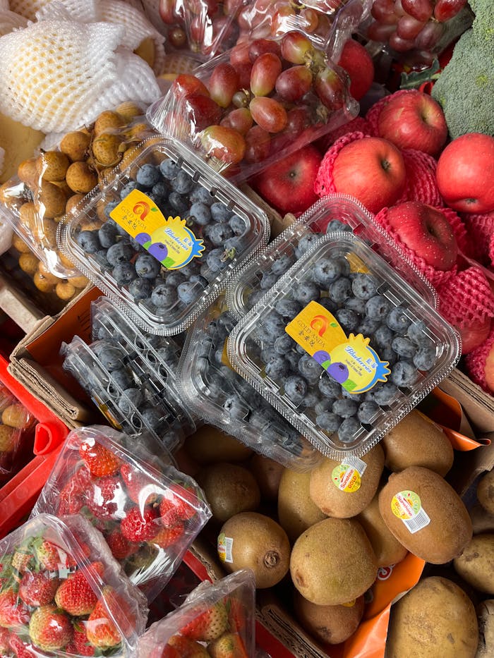 The Art of Drawing Readers In: Your attractive post title goes here Vibrant array of fresh fruits in a market featuring blueberries, kiwis, and apples.